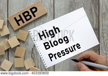 Hbp High Blood Pressure Text On Notepad Page And Wood Block On Wooden Table