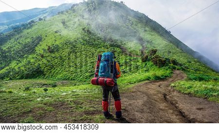 Man Standing On Top Of The Mountain