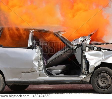 Very Thick Orange Smoke Coming Out Of The Crashed Car Completely Destroyed After The Traffic Acciden
