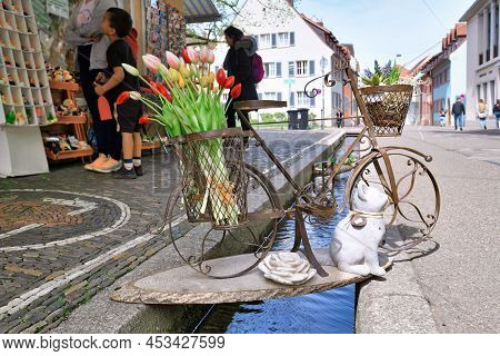 Freiburg, Germany - April 2022: Decorative Bicycle With Tulip Flowers Over Stream Called 'bächle' Le