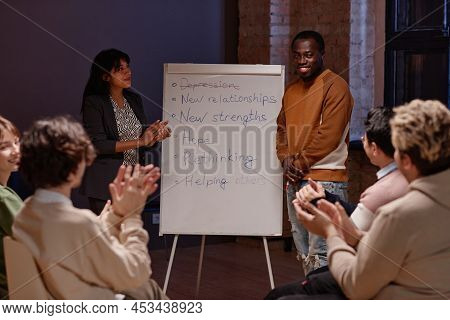 Horizontal Shot Of People Clapping Hands To Joyful Black Man Successfully Finishing Depression Treat