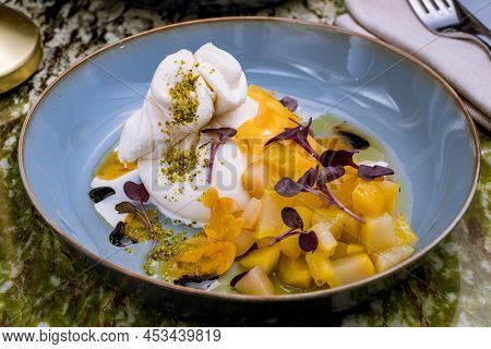 Salad With Buratta Cheese On Grey Plate On Green Marble Table
