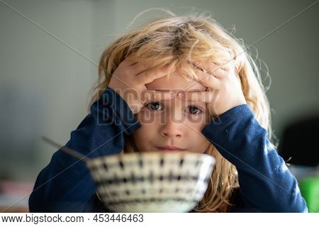 Child Have A Breakfast. Sad Boy Eating Healthy Chicken Noodle Soup For Lunch. Unhappy Baby Child Tak
