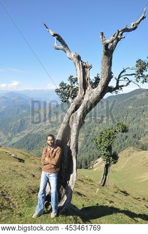 Full Length Of A Good Looking Young Guy Looking At Camera Posing With Crossed Arms While Leaning Aga