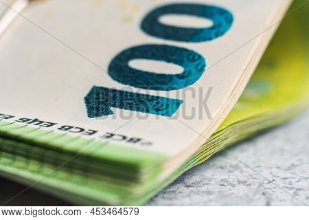 Extreme Close-up Photo Of One Hundred Euro Banknote. Stack Of Paper Currancy Bills. Selective Focus.