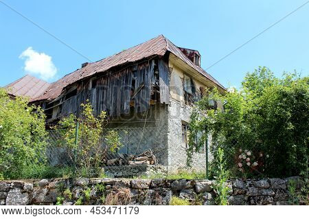 Very Old Abandoned Dilapidated Cracked Wooden Boards Suburban Family House Built On Concrete And Sto