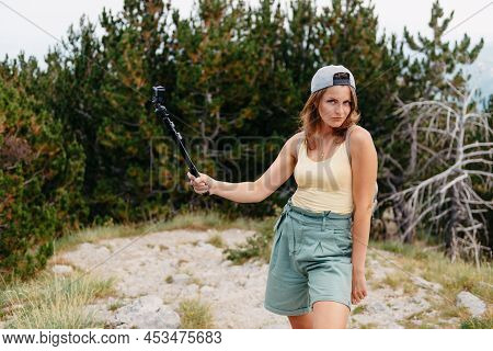 Woman Traveler Hipster Looking Forward At Amazing Mountains And Valley View. Space For Text. Wearing