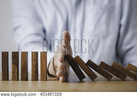 Businessman Hand Stop Wooden Block Falling Others Block Dominos For Risk And Crisis Management Conce