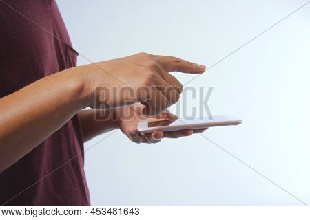 Close-up White Isolated Background Man's Hand Using The Smartphone For Surfing The Internet.