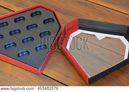 Gift Box. Open Heart-shaped Paper Box In Black Plastic With Aged Wooden Base, Red And Black Box, Bra