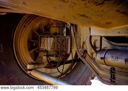 Newman, Western Australia - July 11, 2018: Detail Of Axle And  Shock-absorber Of Yellow Wabco Haulpa