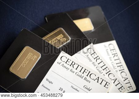 Several Gold Bars Of Different Weights In A Blister Package With A Certificate.  Selective Focus.