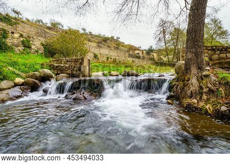 Stream Of Water Coming Down From The Mountain In The Pretty Village Of Hervas, Caceres.