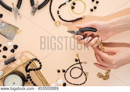 Tools And Accessories For Diy Jewelry In The Workplace. Female Hand With Wire Cutters. Flat Lay On B