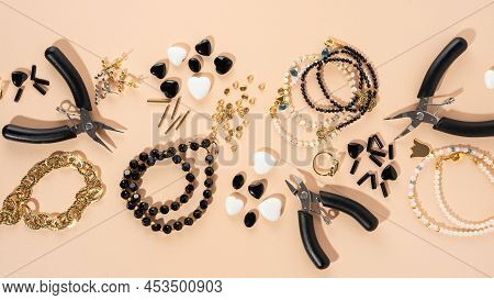 Tools And Accessories For Diy Jewelry In The Workplace. Flat Lay On Beige Background. Creative Flat