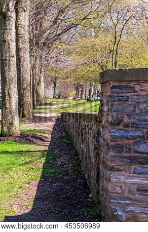 A Stone Wall Casting Its Shadow Next To A Line Of Trees In Frick Park Located In Pittsburgh, Pennsyl