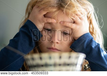 Portrait Of Sad Child Having Breakfast At Home. Portrait Of Sweet Little Kid Boy With Blonde Hair Ea