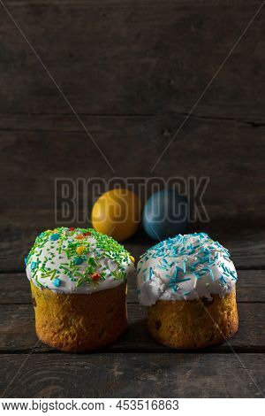 In The Foreground There Are 2 Easter Cakes, In The Back There Are Painted Eggs For Easter In The Col