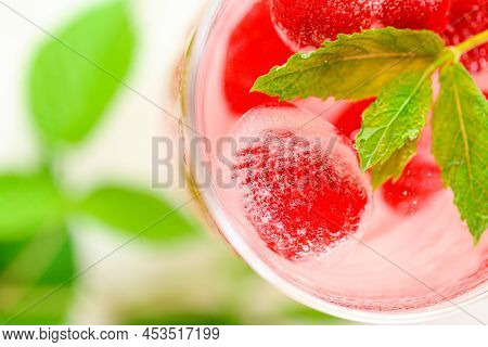 Summer Drink.raspberry Pink Drink.ice Cubes With Raspberries In A Glass With Water, Berries And Rasp