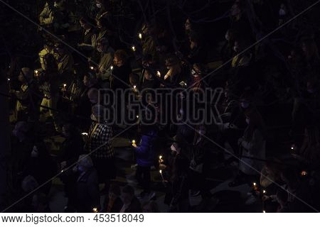 Thessaloniki, Greece - April 22 2022: Gathered Crowd Holding Candles In The Streets At Night. People