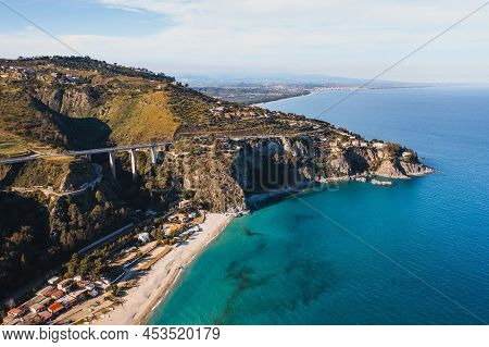 Pietragrande Cliff In Summer Season With Blue Ionic Sea And Rocks In The Calm Water. Aerial Shoot In