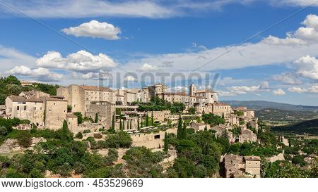 Breathtakingly Picturesque Sky With Floating White Clouds Over Medieval Gordes Village, Rock And Lub