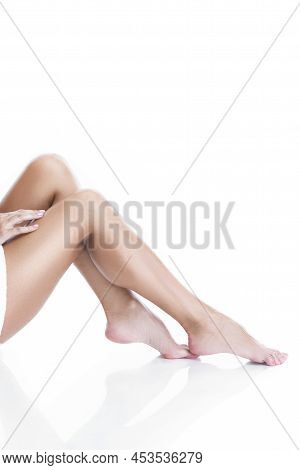 Skincare Ideas And Concepts. Perfect Female Body With Straight Tanned Legs Wrapped With White Bath T