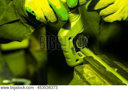 Hands Of Professional Fitter In Protective Gloves And Uniform Using Precision Curcular Saw For Metal