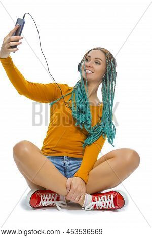 Winsome Positive Caucasian Female With African American Dreadlocks Taking Selfie With Cellphone Whil