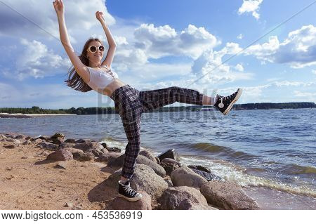 Natural Summer Portrait Of Sensual Caucasian Blond Female Girl In Casual Street Clothing Posing Whil