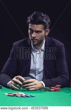 Gaming Concepts. Emotional Handsome Caucasian Brunet Pocker Player At Pocker Table With Chips And Ca