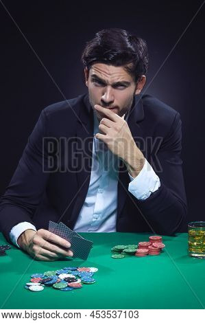 Gaming Concepts. Emotional Handsome Caucasian Brunet Pocker Player At Pocker Table With Chips And Ca