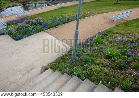 Between The Stairs Is A Waterfall With Stones And Boulders. Artificial Stream With A Waterfall Betwe