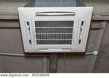Supply And Exhaust Air Conditioner On The Concrete Ceiling Of An Industrial Building. Cassette Type 