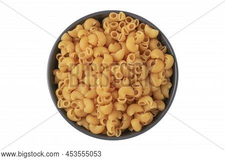 Dry Uncooked Pasta In A Black Ceramic Cup Isolated On A White Background. View From Above