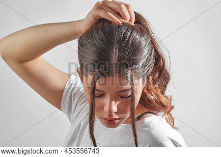 Portrait Young Woman In Studio On Graybackground. Youth Concept