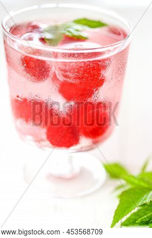 Raspberry Cocktail.summer Drink.raspberry Pink Drink.ice Cubes With Raspberries In A Glass With Wate