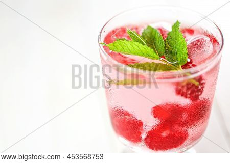 Raspberry Cocktail.summer Drink.raspberry Pink Drink.ice Cubes With Raspberries In A Glass With Wate