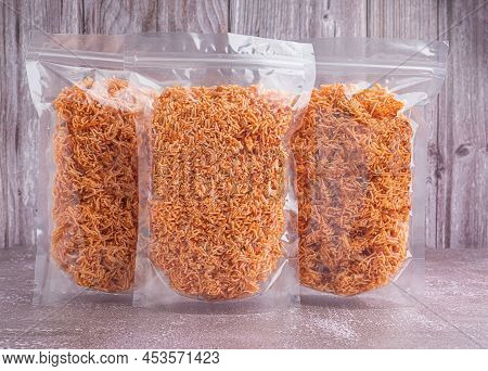 Side View Of Sweet And Sour Crispy Noodles Or Mee Krob In The Thai Language In A Clear Package Place