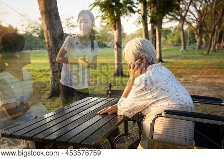 A Lonely Senior Woman Is Waiting And Thinking Old Memories Of Her Family That Will Visit Her Again,d