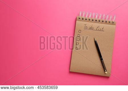 Notepad With Unfilled To Do List And Pen On Pink Background, Top View. Space For Text