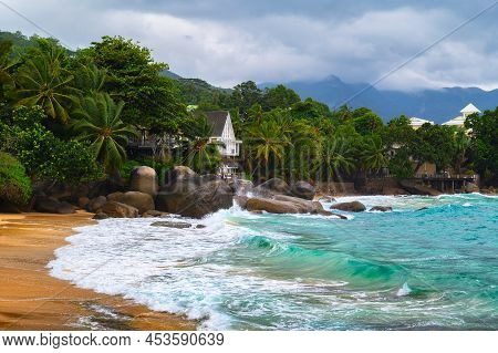 Glacis Beach At The Mahe Island, Seychelles, With Strong Waves And Heavy Clouds. Popular Sand Beach 