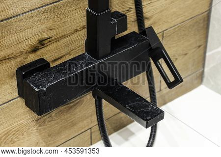 Black Faucet With Limescale Deposits Due To Water Hardness Close-up