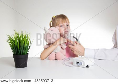 A 5-year-old Caucasian Girl Is Breathing Into An Inhaler At Home. Treatment Of Cough And Lung Diseas