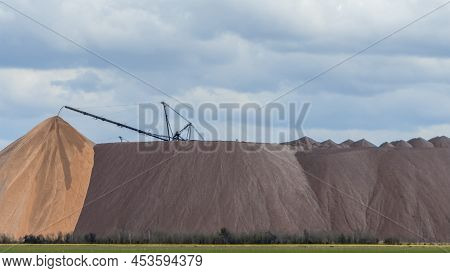 Giant Spreader Or Absetzer Machinery. A Large Dumper On A Landfill With Potash Ore. Extracting And M