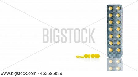 Yellow Film Coated Tablets Pills In Blister Packs And Group Of Round Yellow Tablets Pills On White B