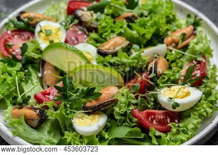 Close Up Salad With Mussels, Quail, Egg, Conjugate, Lime, Spinach Lettuce, Cherry Tomatoes And Micro