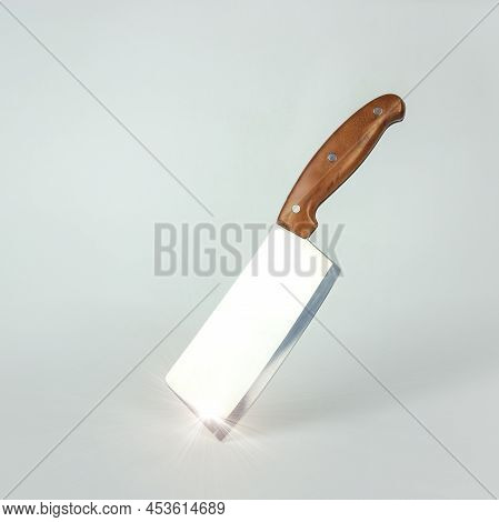 Steel Kitchen Knive On White Background. Kitchen Knife Balanced On Its End.