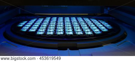 Silicon Wafer With Chips In Uv Lighting. Neon. Ultraviolet Lithography.