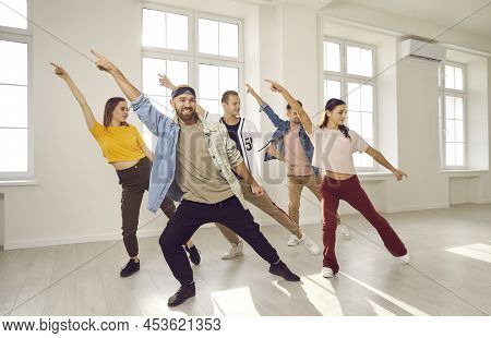 Group Of Energetic Hip Hop Dancers Have Fun Rehearsing Dance Moves While Learning New Dance.